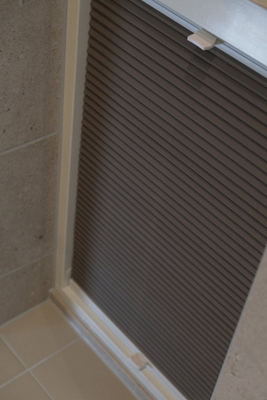 Plisségardin på mål montert på bad med innsynsskjerming